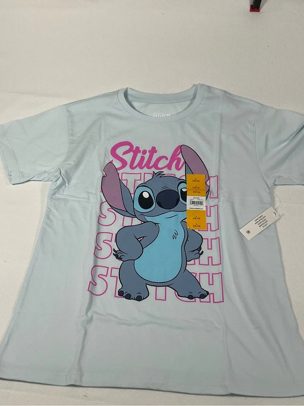 Disney Light Blue Stitch Tee with Pink and Purple. New with Tag.size L(10/12)